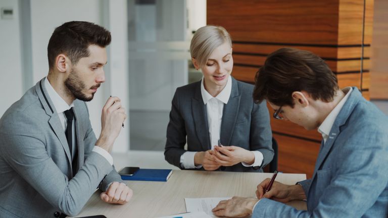 Professional team in business meeting, discussing strategy at office.